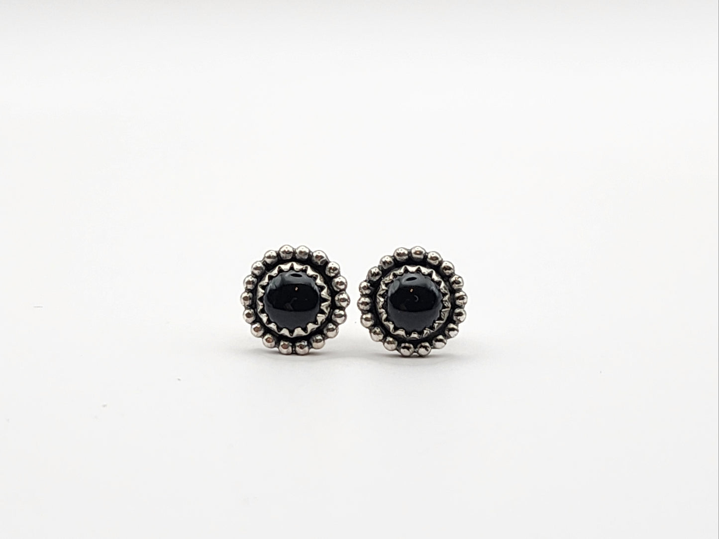 Pair of black onyx stud sterling silver earrings on a white background