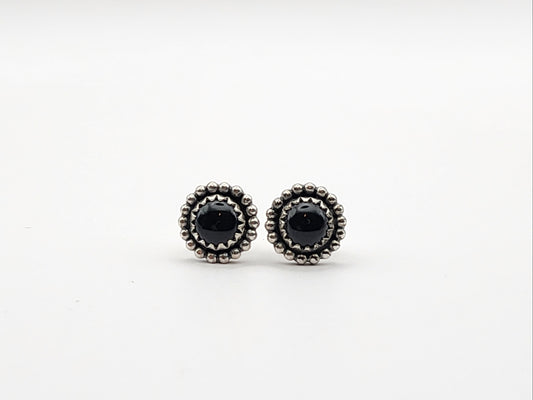 Pair of black onyx stud sterling silver earrings on a white background